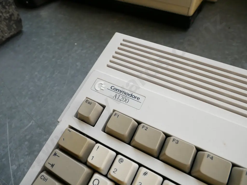 3x Commodore Amiga keyboard/computers and box of power supplies and other accessories Image 1++