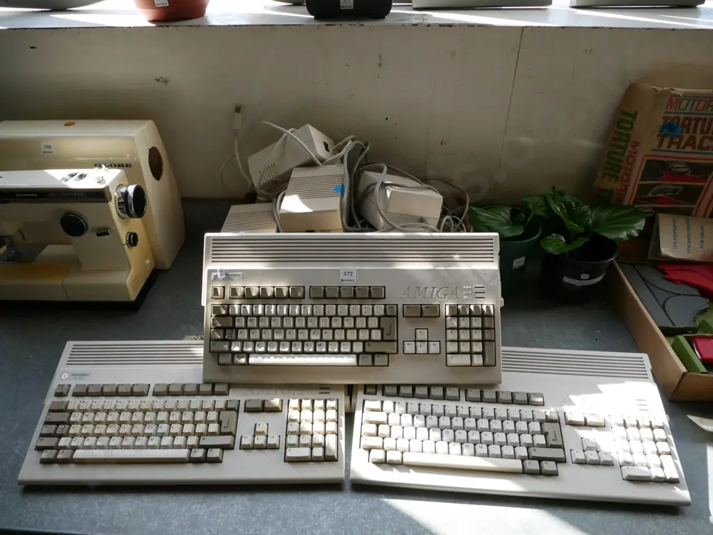 3x Commodore Amiga keyboard/computers and box of power supplies and other accessories Image 1++