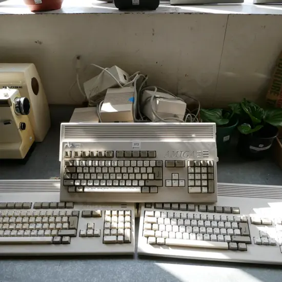 3x Commodore Amiga keyboard/computers and box of power supplies and other accessories