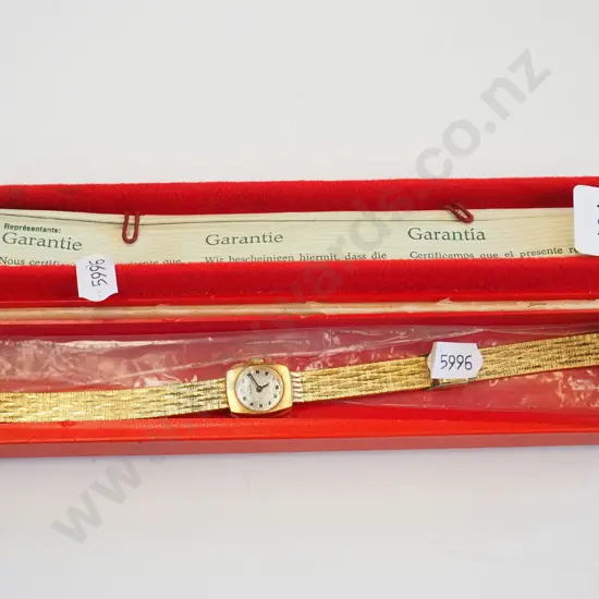 golden wristwatch in case