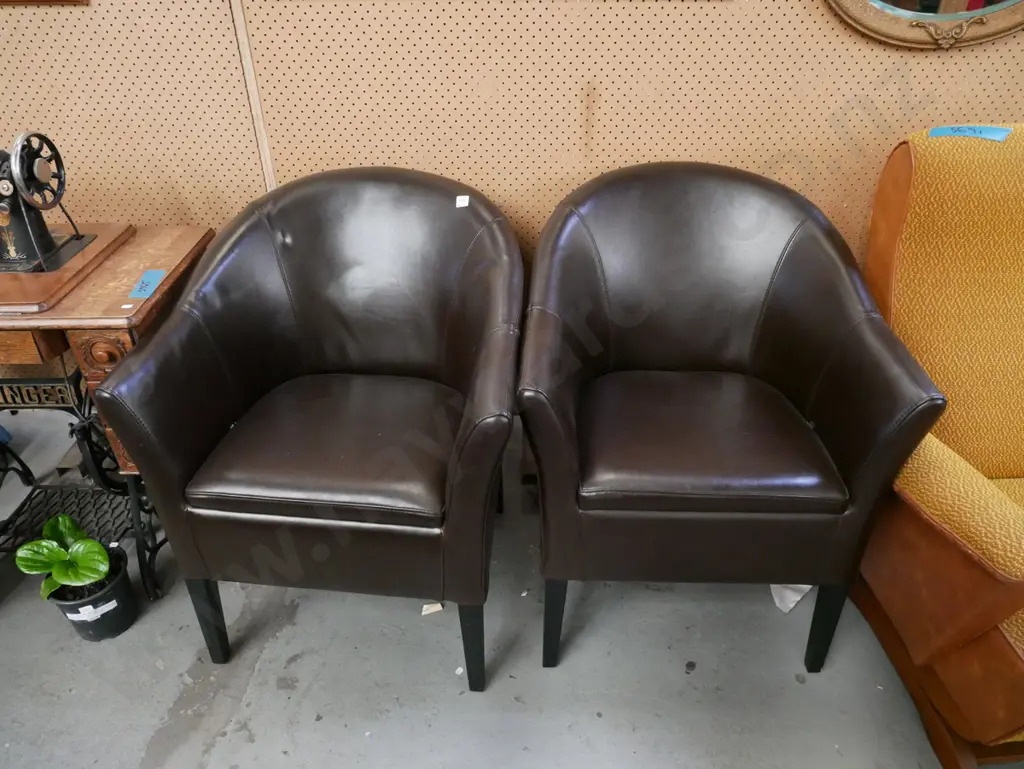 pair of brown vinyl tub chairs Image 1++