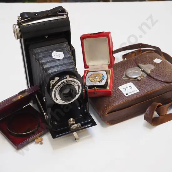 vintage concertina camera, lens, light meter