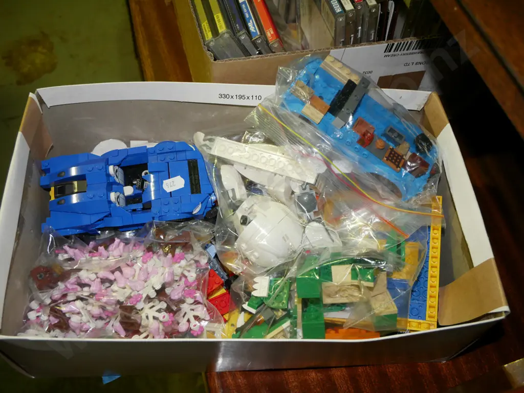 box of Lego pieces Image 1++