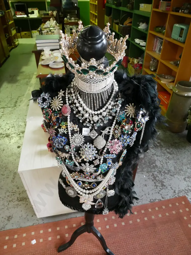 mannequin torso on stand - decorated with feather boa and numerous costume brooches and tiara Image 1++