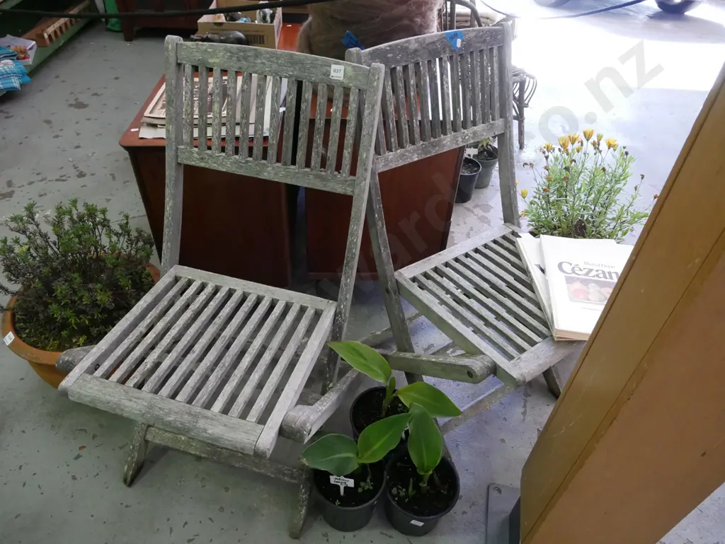 pair of well weathered hardwood deck chairs Image 1++