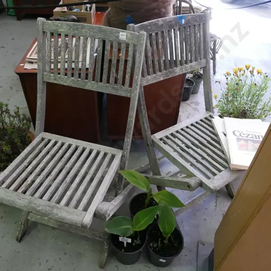 pair of well weathered hardwood deck chairs