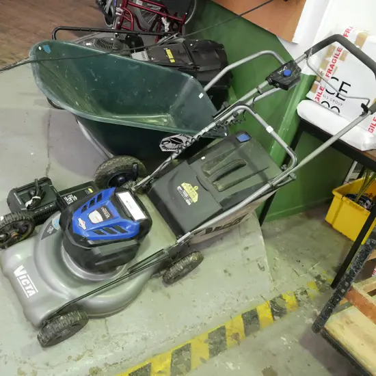 Victa 82V battery powered lawn mower with charger - battery in office