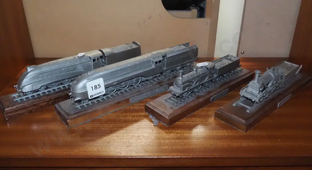 4x die cast model trains on wooden plinths Image 1++