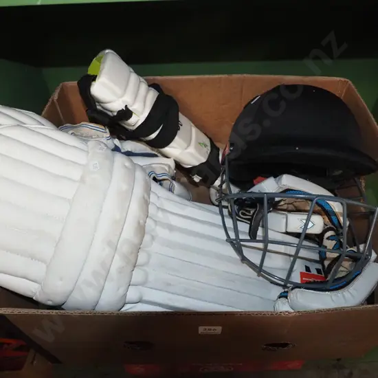 box; cricket gloves, pads, and helmet