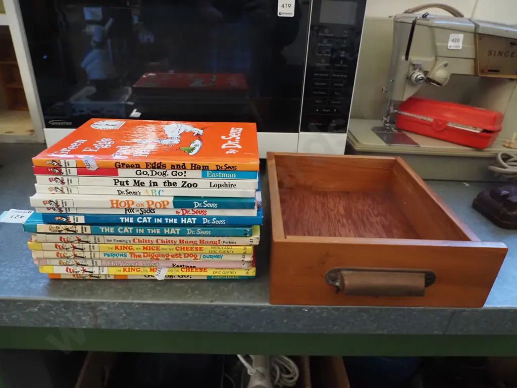 Dr. Seuss books in a small timber drawer with metal handle Image 1++