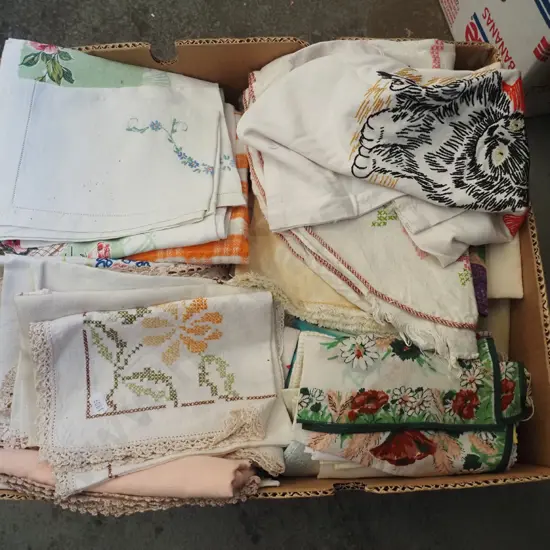 box of hand worked linen, tea towels etc
