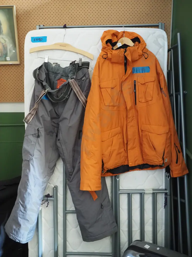 orange ski jacket and grey pants Image 1++