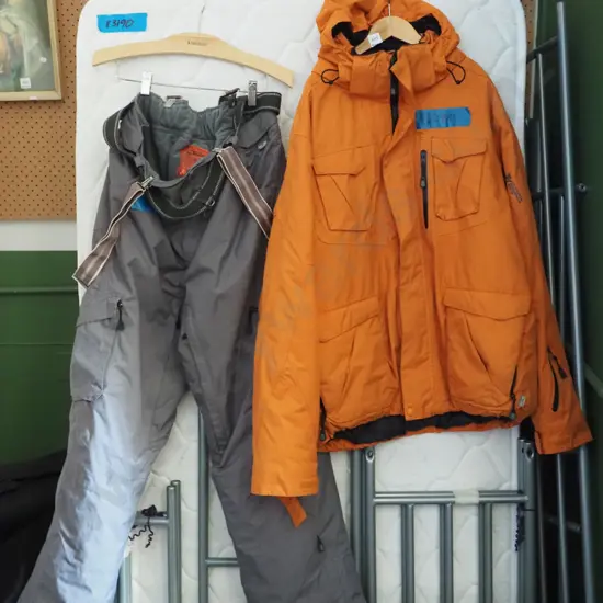 orange ski jacket and grey pants