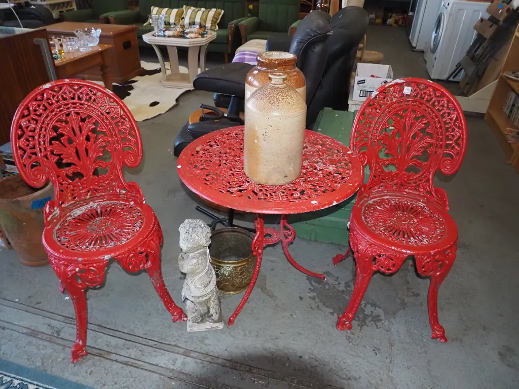 red painted cast alloy patio table with 2 chairs Image 1++