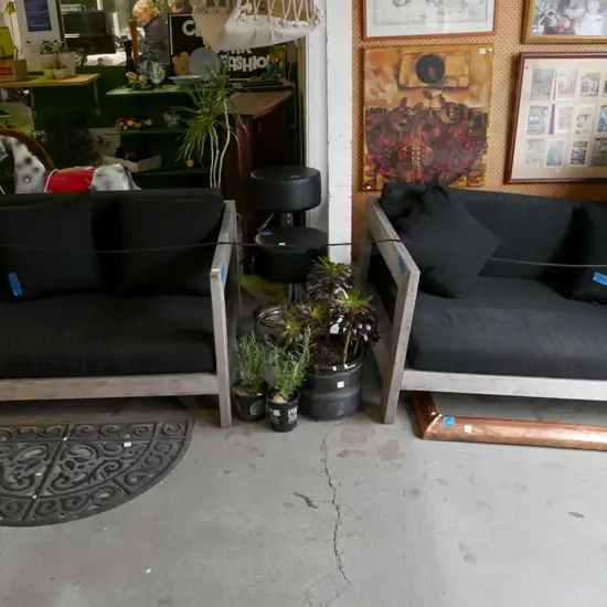 pair of matching outdoor 2 seater couches with removable padding and cushions