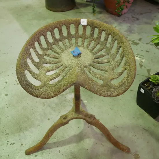 rusty tractor seat stand
