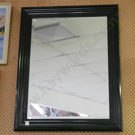 black framed wall mirror
