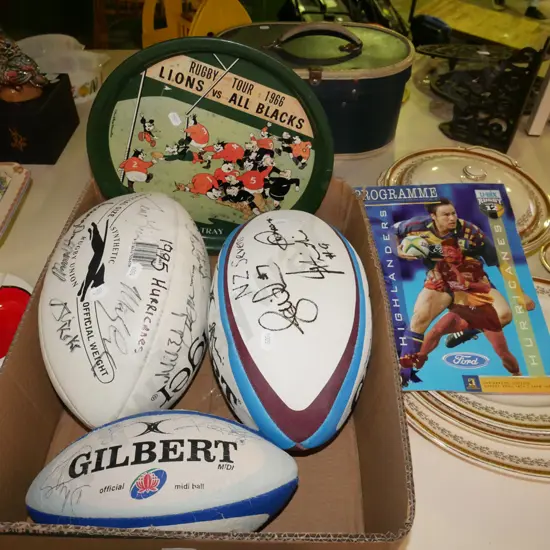 box; 3x signed rugby balls, Lions All Blacks Blacks tray, 1998 Highlanders rugby programme