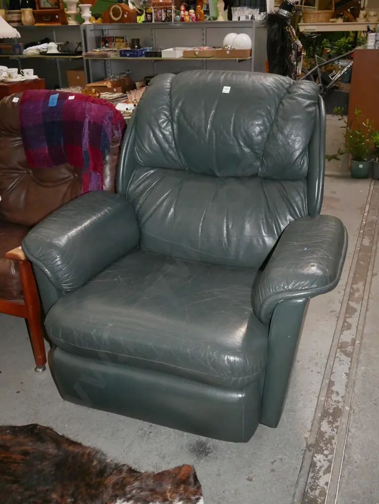 green leather upholstered reclining armchair on casters -wear to leather Image 1++