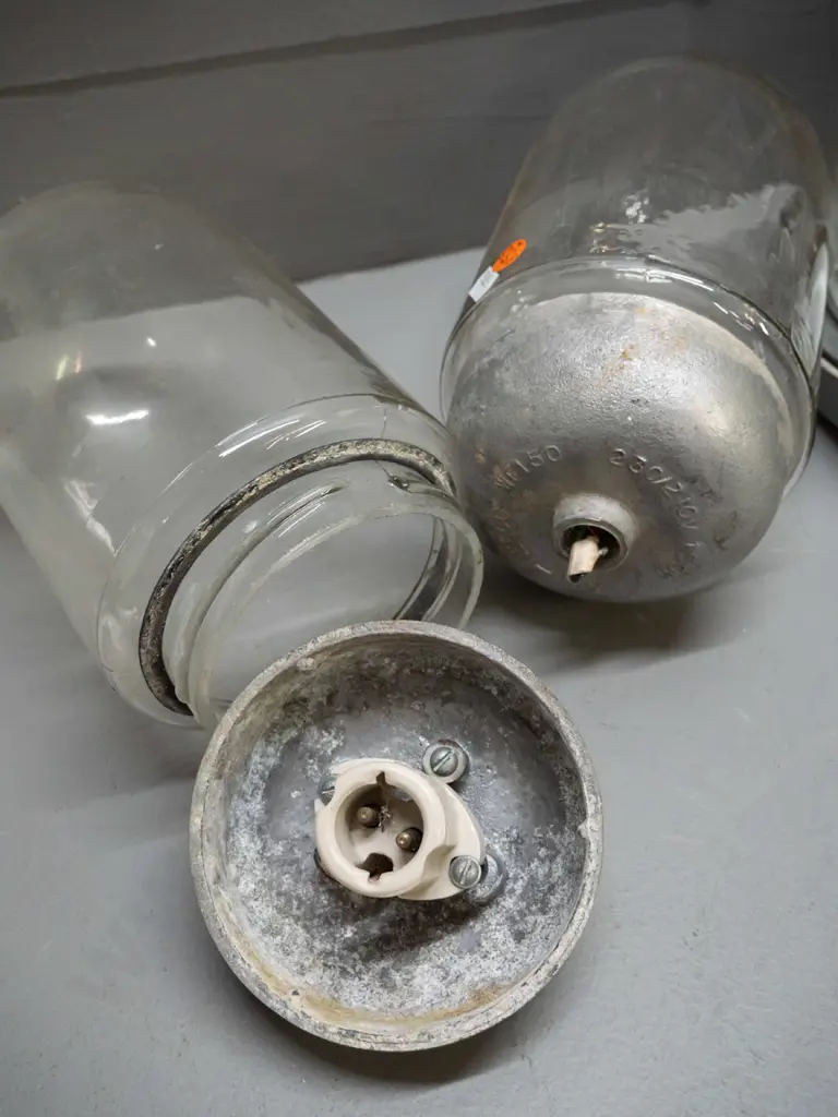 3 industrial or ship's light fittings with heavy cast metal housing and glass dome shades, pair of smaller ones Image 1++