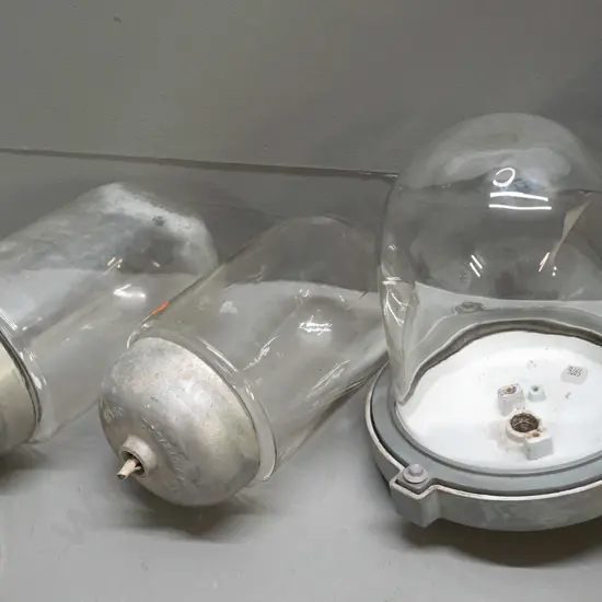 3 industrial or ship's light fittings with heavy cast metal housing and glass dome shades, pair of smaller ones