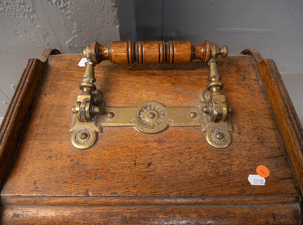 vintage oak coal scuttle with brass door-opening mechanism connected to brass and timber top handle, with tin liner. Image 1++