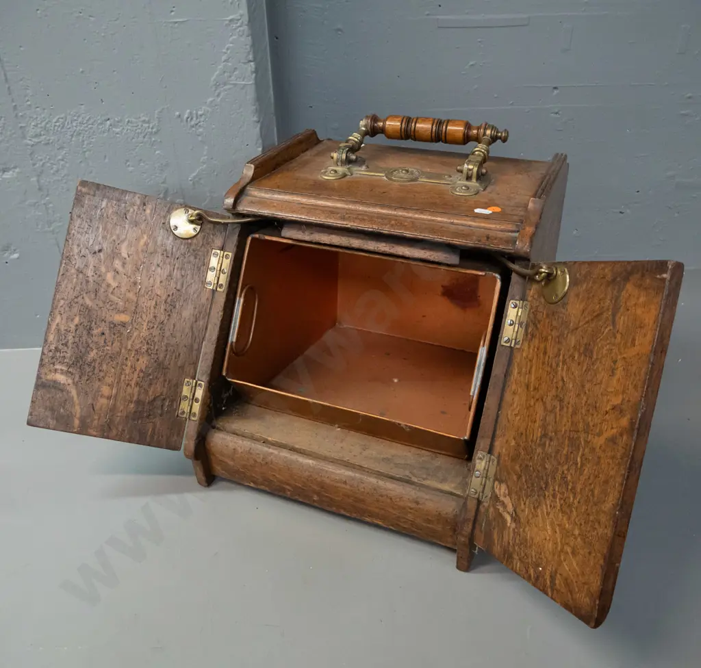 vintage oak coal scuttle with brass door-opening mechanism connected to brass and timber top handle, with tin liner. Image 1++
