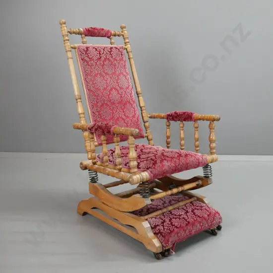 vintage mixed timber Dexter rocking chair slide-out foot rest, porcelain casters on foot rest. Some wear to red embossed