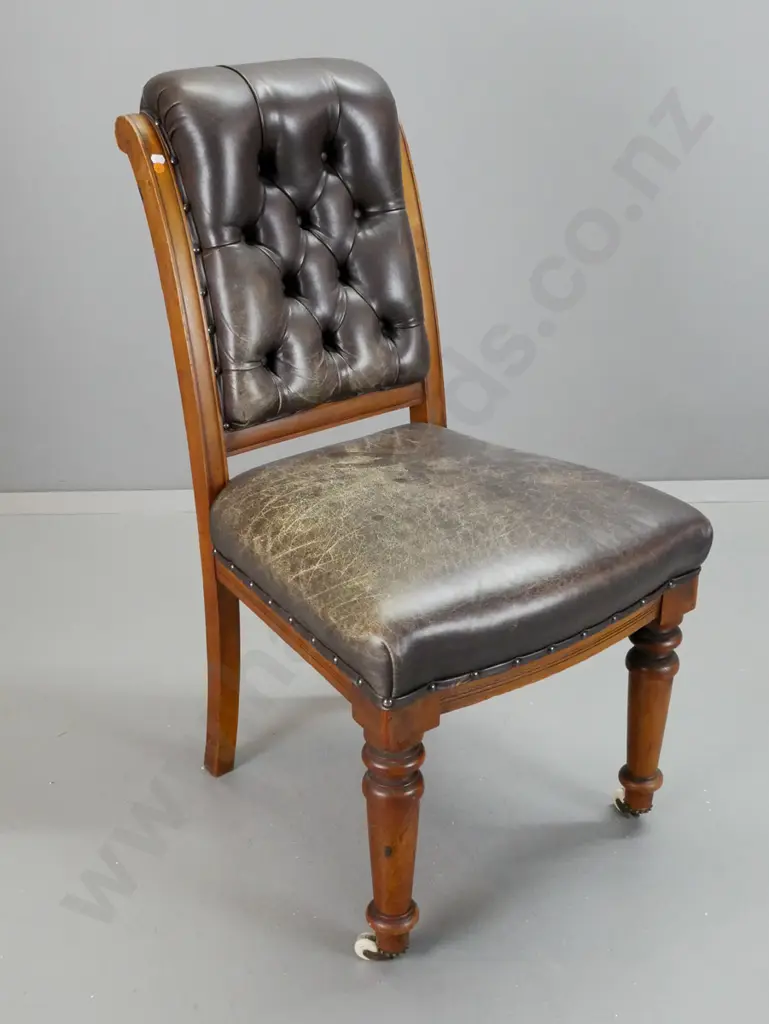 Victorian rimu Cromwellian style chair with deep button leather back, turned front legs, brass crown feet on porcelain Image 1++