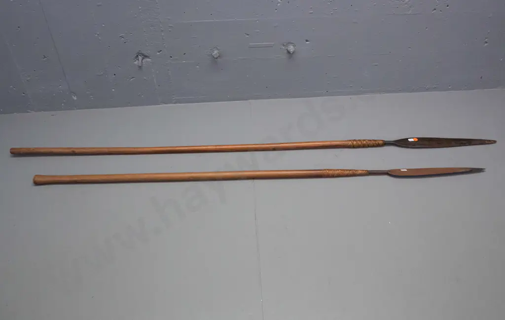 2 tribal spears with timber shaft, metal blades attached with woven cane. Some corrosion to blades, longer one is L-1480 Image 1++