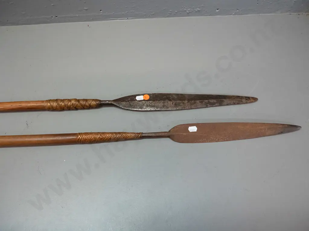 2 tribal spears with timber shaft, metal blades attached with woven cane. Some corrosion to blades, longer one is L-1480 Image 1++