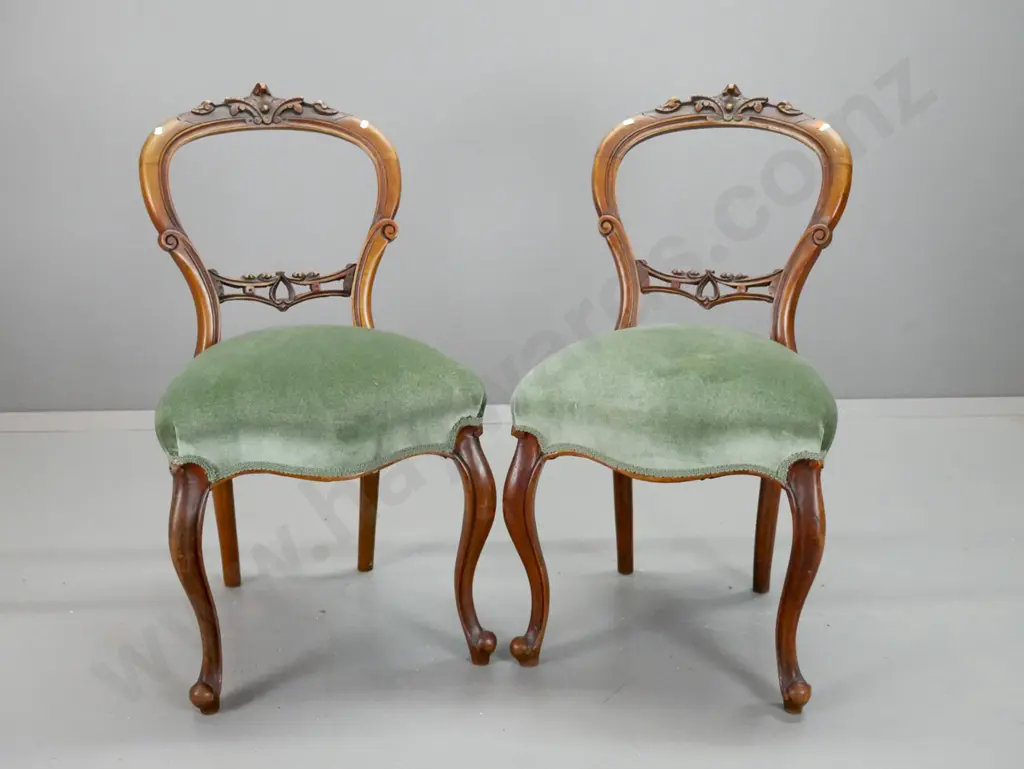 pair of Victorian walnut cab-leg balloon back chairs with carved back splat and crest, green velvet upholstered seat. Image 1++