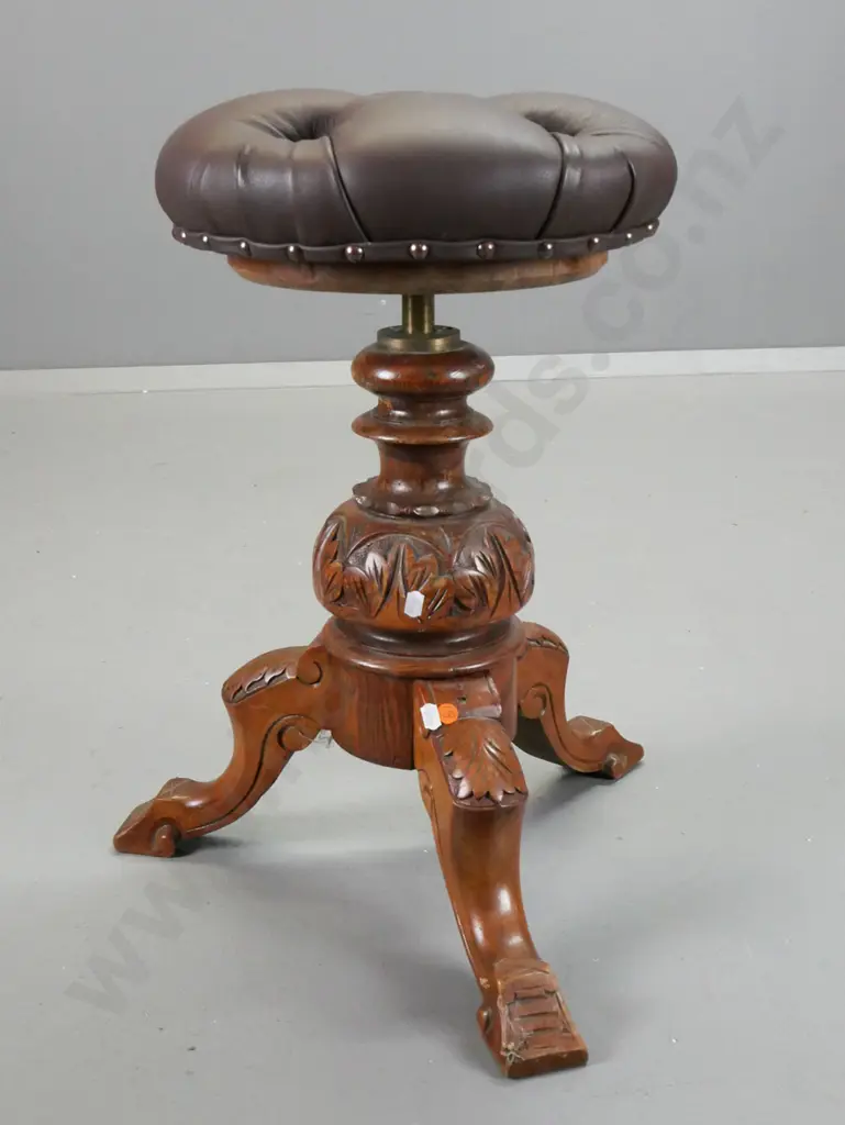 Victorian elm piano stool with revolving height adjustable seat, covered in deep button vinyl, borer holes in seat base Image 1++