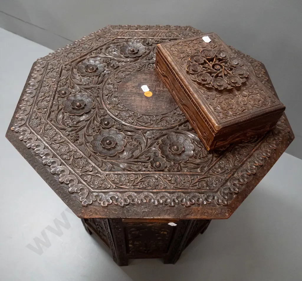 intricately carved and pierced Asian hardwood collapsible table with octagonal top, hinged stand, with similar carved Image 1++
