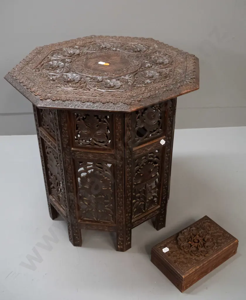 intricately carved and pierced Asian hardwood collapsible table with octagonal top, hinged stand, with similar carved Image 1++
