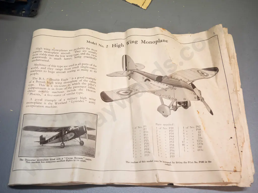 vintage metal Meccano aeroplane construction kit pieces - assorted wings, wheels, and body parts, booklet missing covers Image 1++