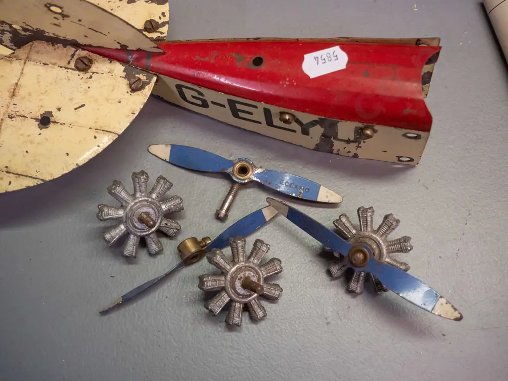 vintage metal Meccano aeroplane construction kit pieces - assorted wings, wheels, and body parts, booklet missing covers Image 1++