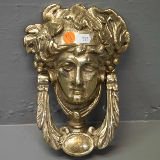 cast brass figural door knocker with Romanesque face - some pitting and discolouration. H-170 W-120