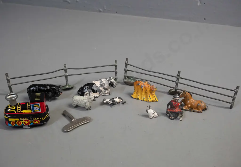 vintage lead toy farm animals, farmer, fence etc. and a small reproduction wind-up tin toy locomotive and a clock key - Image 1++