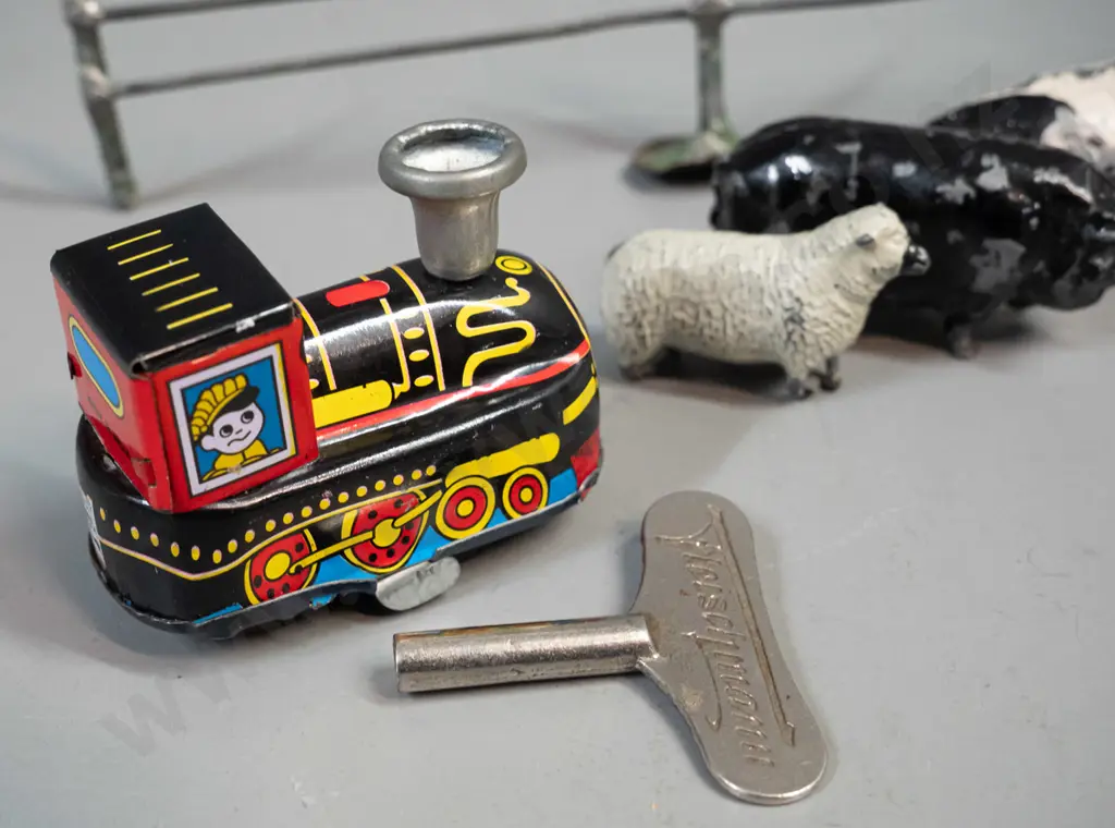 vintage lead toy farm animals, farmer, fence etc. and a small reproduction wind-up tin toy locomotive and a clock key - Image 1++