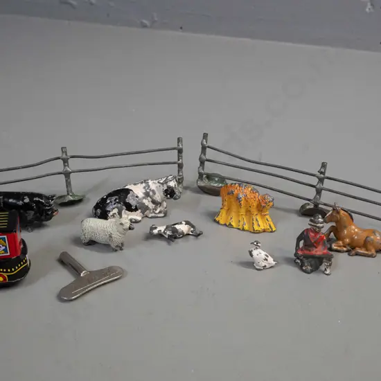 vintage lead toy farm animals, farmer, fence etc. and a small reproduction wind-up tin toy locomotive and a clock key -