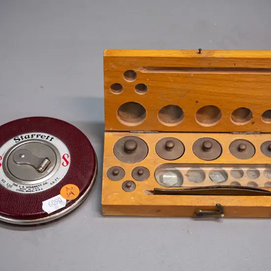 wood-cased set of gold scale weights and a Starrett USA measuring tape D-100