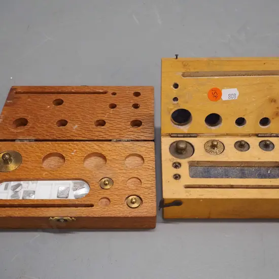 2 part timber cased gold scale weight sets with brass and other metal weights - both missing some elements. Larger is