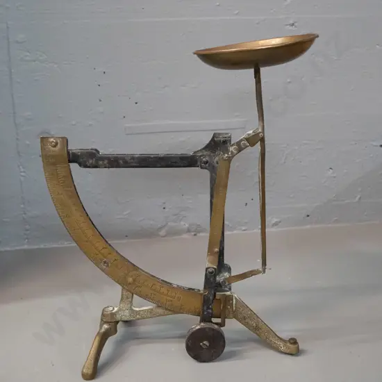 vintage brass folding swing-arm balance scales marked "dilarang untuk berdagang" which is Malay according to Google.