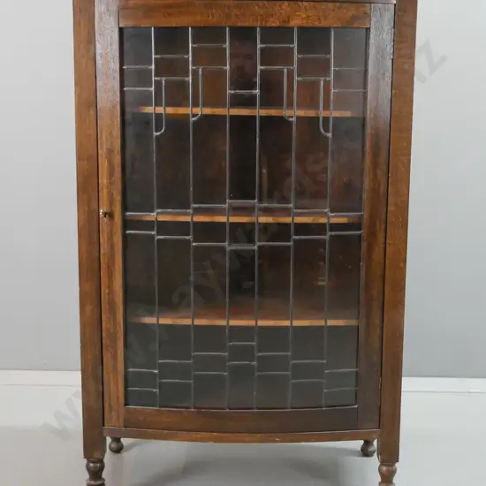 oak arts & crafts style display cabinet with panelled sides, one bowed leadlight door, 3 fixed shelves, on short turned