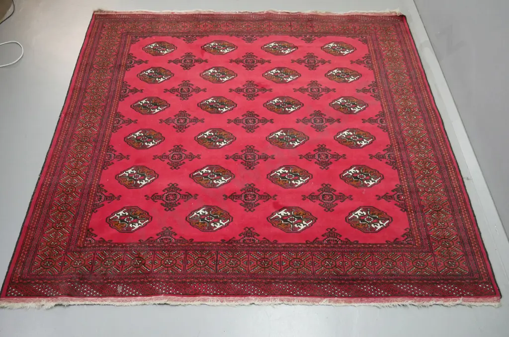 hand knotted wool floor rug - label marked Turkoman - red, black , brown and cream. Some staining. L-1940 W-2000 Image 1++
