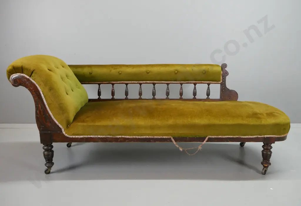 Edwardian beech rail-back chaise longue with carved foliate decoration, turned legs on casters, olive green buttoned Image 1++
