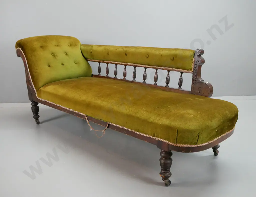 Edwardian beech rail-back chaise longue with carved foliate decoration, turned legs on casters, olive green buttoned Image 1++