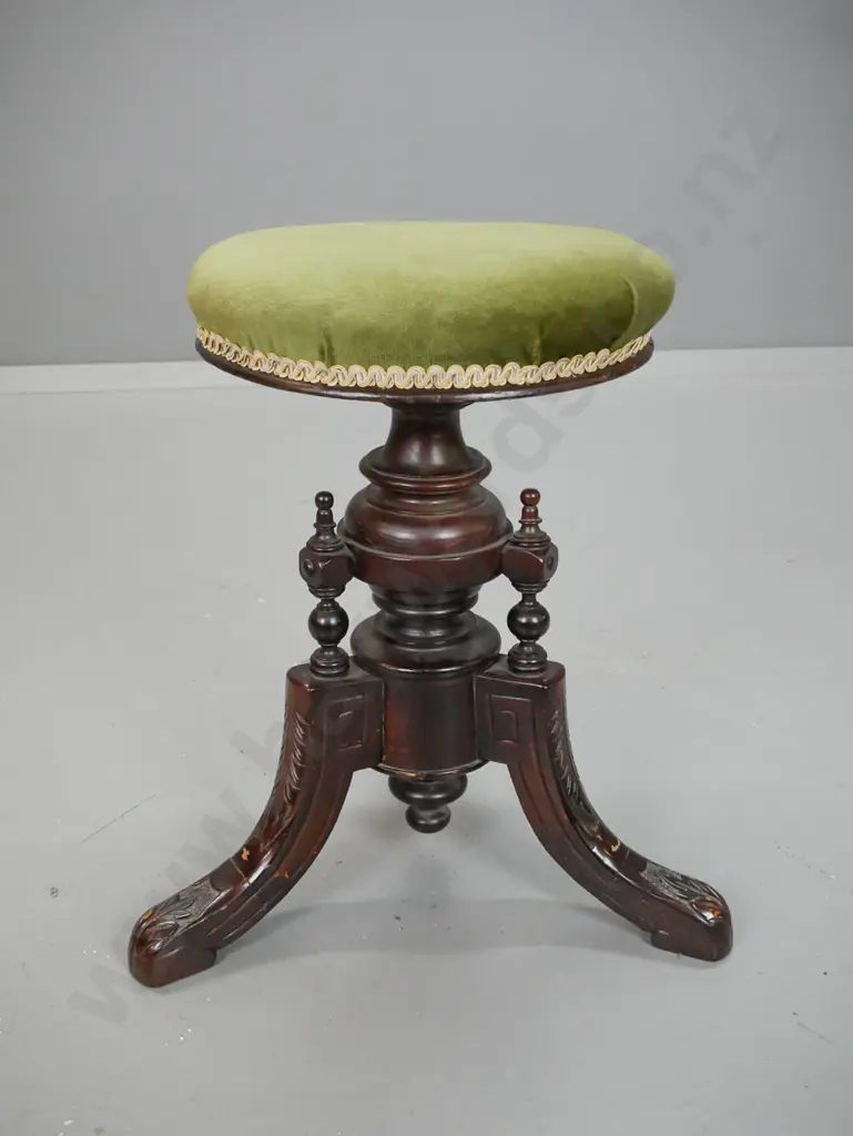 Victorian elm revolving seat piano stool with 3 shaped carved feet, turned supports, green velvet upholstered seat. Image 1++