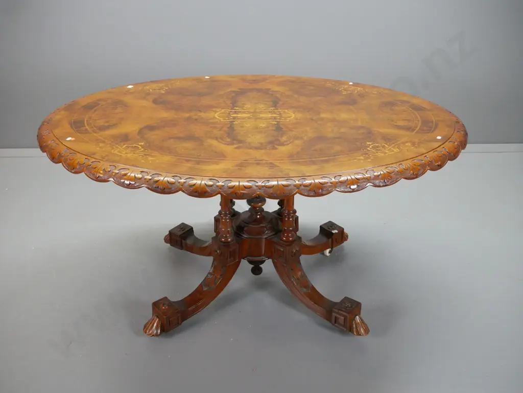 Victorian walnut loo table w/ cross-banded & inlaid boxwood & mixed timber top, shaped and carved edge, on 4-point Image 1++